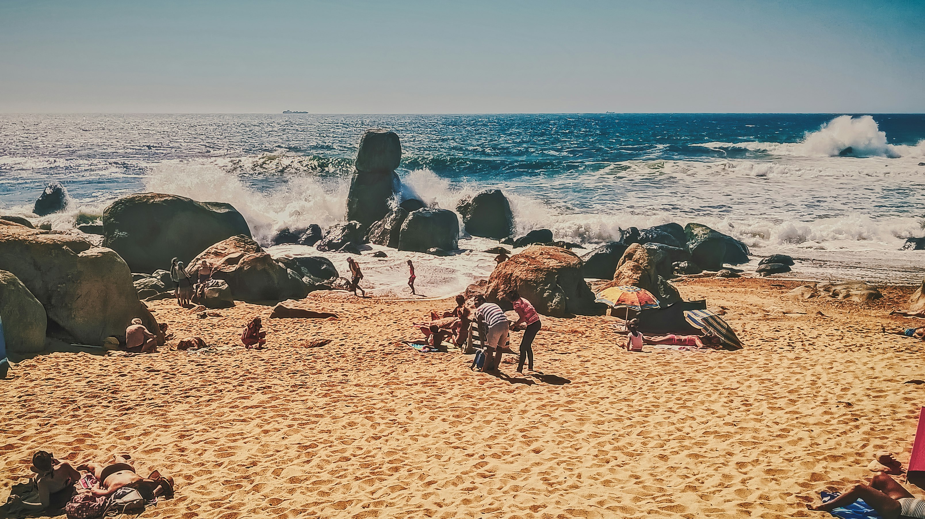 people sitting on beach shore during daytime